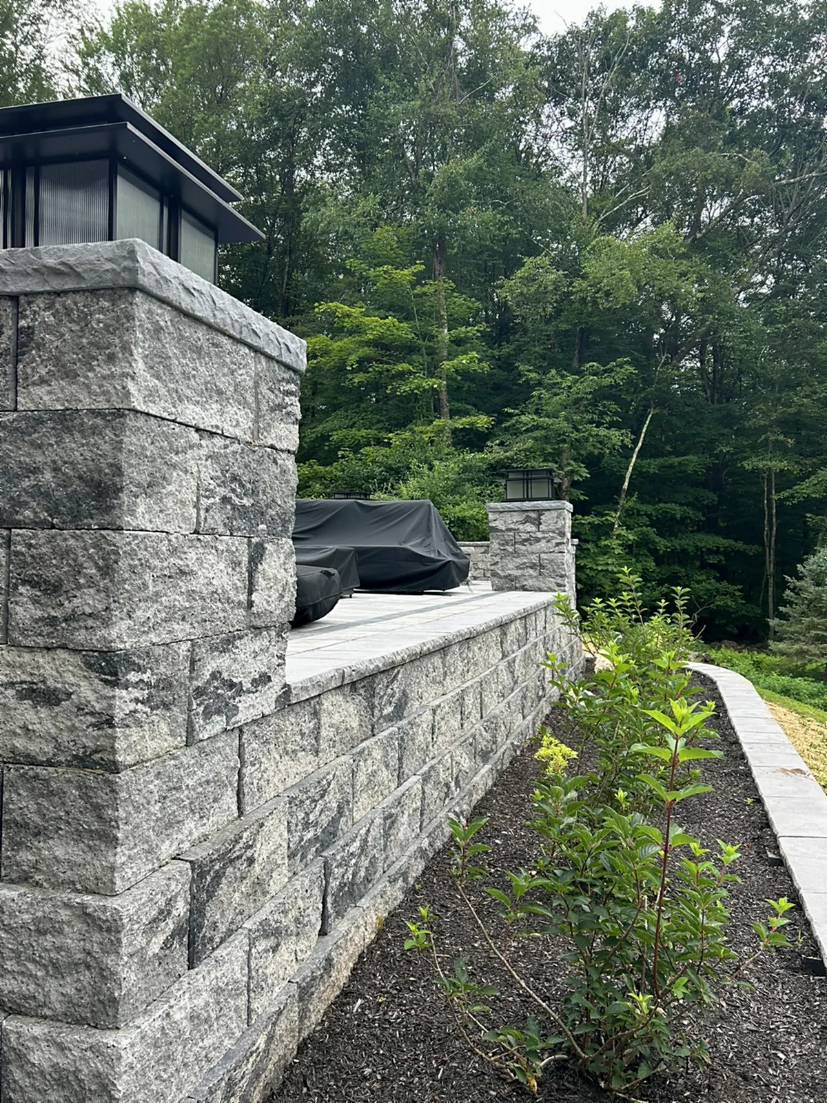 Stone retaining wall and patio